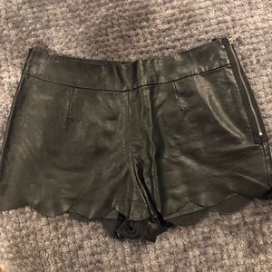 Black leather scalloped shorts with zipper detail